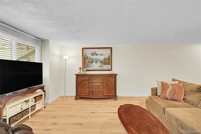 2840 S Kenton Ct, Aurora, CO 80014 - living room with light wood-style floors and a textured ceiling