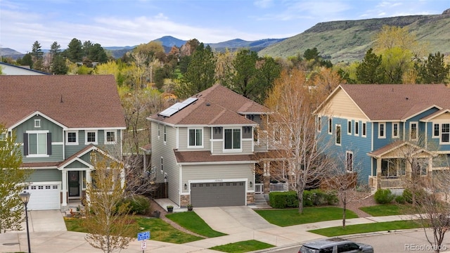 15960 W 62nd Dr, Arvada, CO 80403 - craftsman inspired home with an attached garage, stone siding, a mountain view, driveway, and roof mounted solar panels