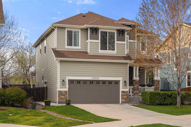 15960 W 62nd Dr, Arvada, CO 80403 - craftsman house featuring fence, an attached garage, stone siding, concrete driveway, and a shingled roof