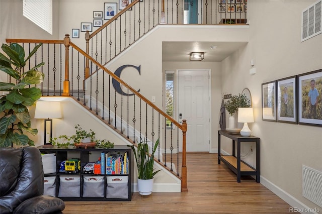 15960 W 62nd Dr, Arvada, CO 80403 - entrance foyer featuring stairs, baseboards, visible vents, and wood finished floors