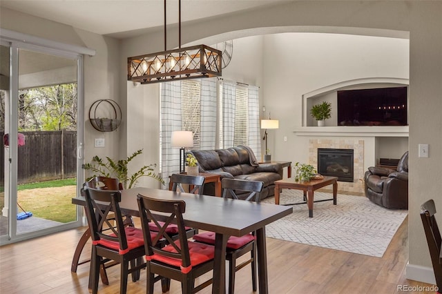 15960 W 62nd Dr, Arvada, CO 80403 - dining area with a tiled fireplace and light wood-type flooring