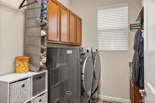 15960 W 62nd Dr, Arvada, CO 80403 - laundry room featuring baseboards, washer and dryer, and cabinet space