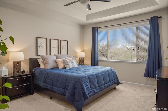 15960 W 62nd Dr, Arvada, CO 80403 - bedroom with light colored carpet, a raised ceiling, baseboards, and a ceiling fan
