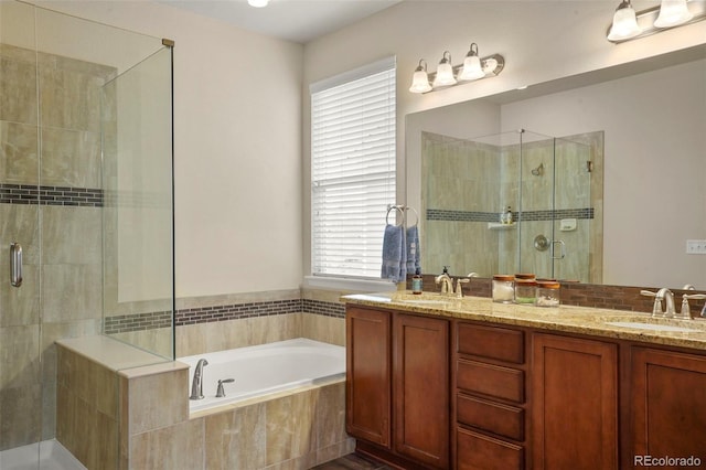 15960 W 62nd Dr, Arvada, CO 80403 - bathroom featuring a shower stall, a bath, double vanity, and a sink