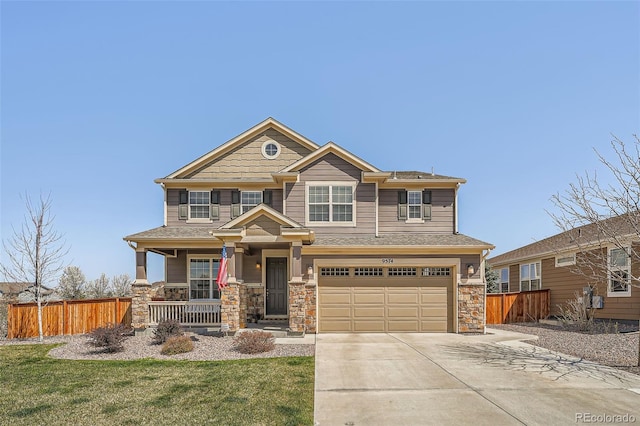 craftsman house featuring a porch, driveway, stone siding, and a garage