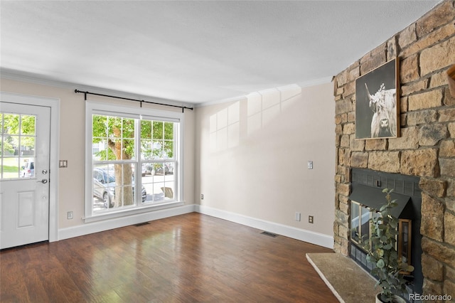 10814 Bayfield Way, Parker, CO 80138 - unfurnished living room featuring crown molding, wood finished floors, plenty of natural light, and a stone fireplace