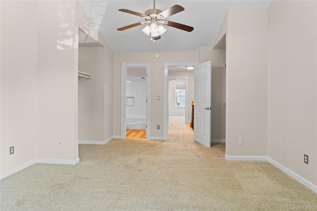 10814 Bayfield Way, Parker, CO 80138 - unfurnished bedroom featuring carpet, a walk in closet, lofted ceiling, ensuite bathroom, and a ceiling fan