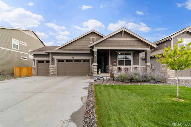 craftsman-style home with a garage, covered porch, and a front lawn