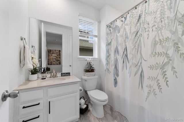 bathroom featuring vanity and toilet