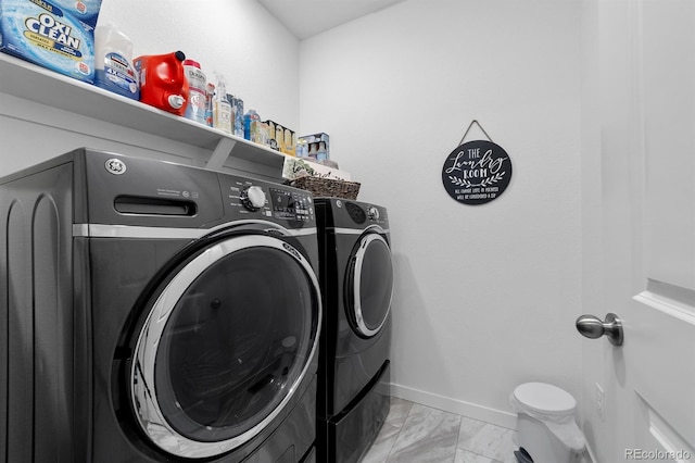 clothes washing area with light tile patterned floors and separate washer and dryer