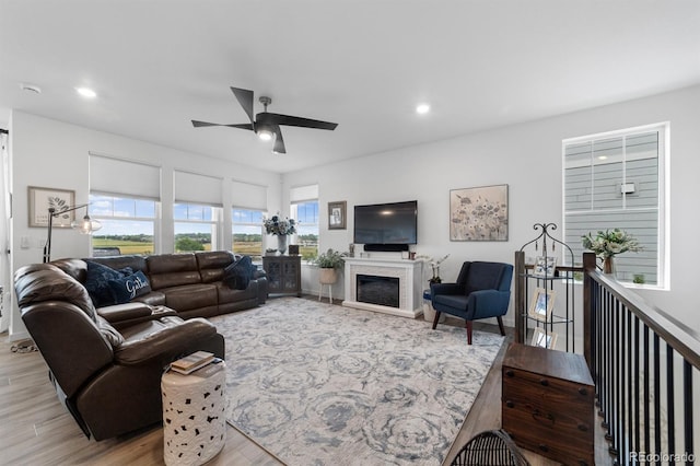 living room featuring light wood-type flooring and ceiling fan