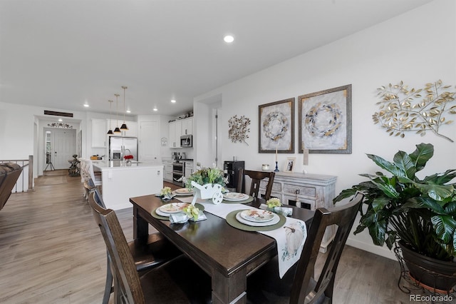 dining space featuring light wood-type flooring