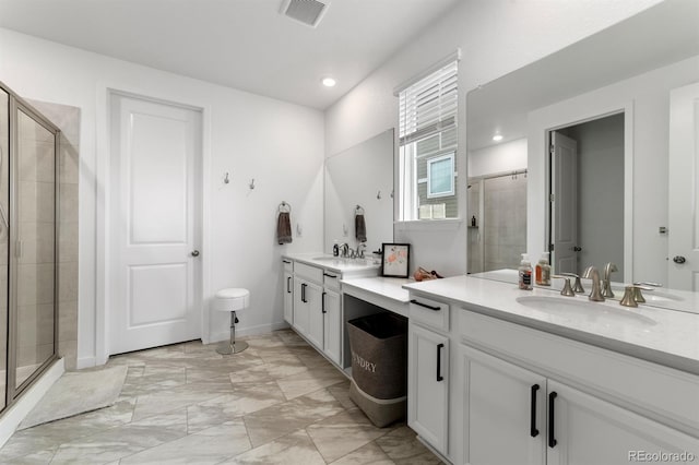 bathroom with tile patterned floors, vanity, and walk in shower