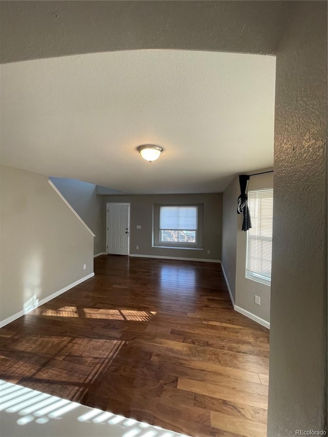 unfurnished room with dark hardwood / wood-style floors