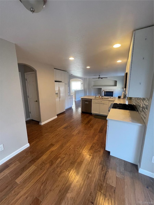 kitchen with white fridge with ice dispenser, white cabinetry, dark hardwood / wood-style floors, and ceiling fan