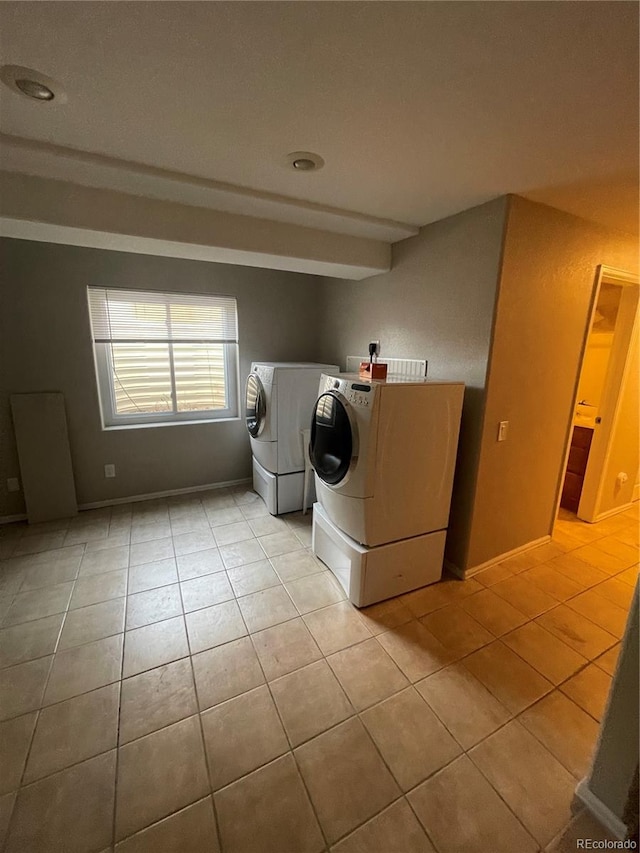 laundry area with light tile flooring and separate washer and dryer