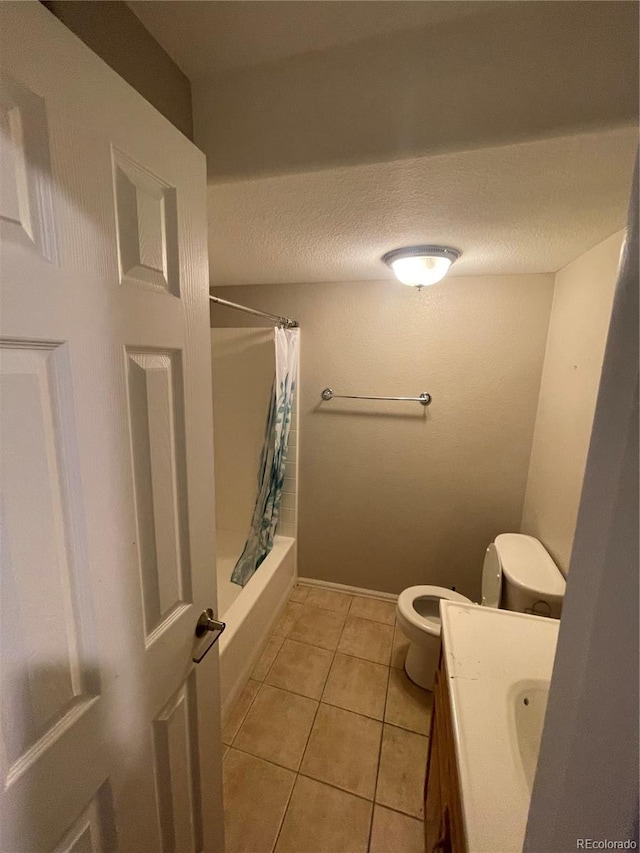 full bathroom with tile flooring, a textured ceiling, shower / tub combo, toilet, and vanity