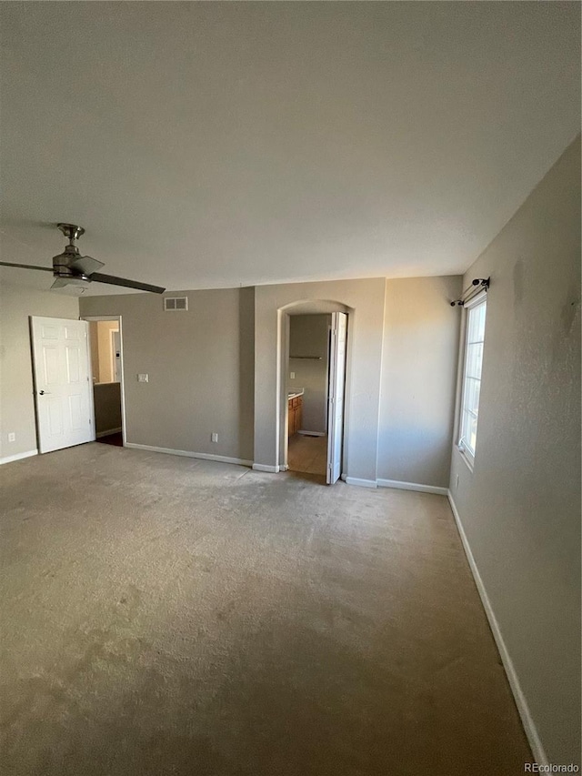 empty room with ceiling fan and carpet