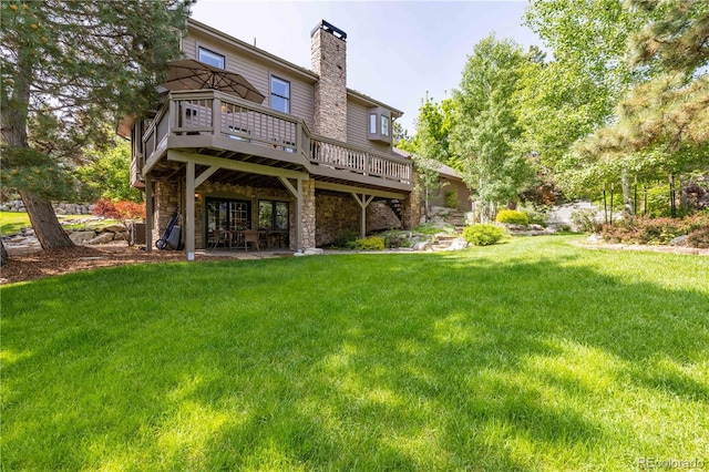 9 Roder Gate Ln, Castle Pines, CO 80108 - back of property with a deck, a chimney, a lawn, and stone siding