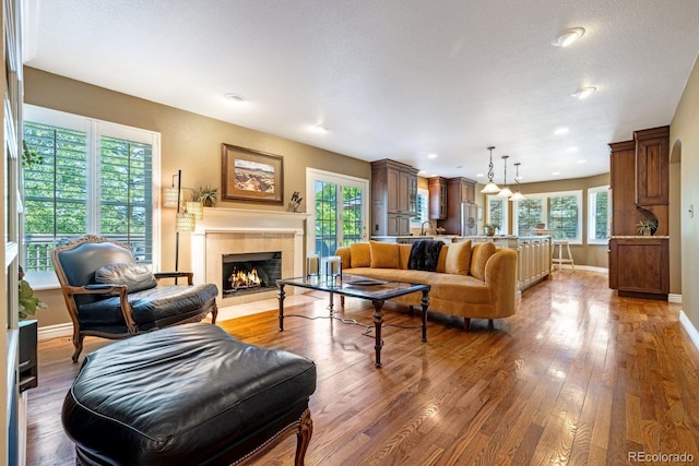 9 Roder Gate Ln, Castle Pines, CO 80108 - living room featuring wood finished floors, a fireplace, baseboards, and recessed lighting