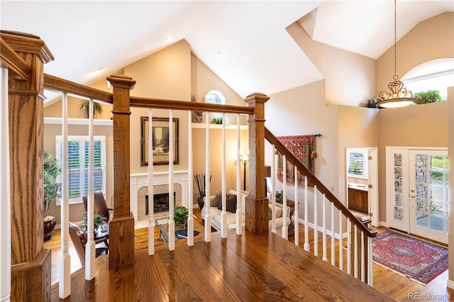 9 Roder Gate Ln, Castle Pines, CO 80108 - living area with high vaulted ceiling, wood finished floors, healthy amount of natural light, and a fireplace