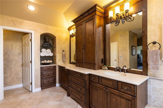 9 Roder Gate Ln, Castle Pines, CO 80108 - full bath with double vanity, tile patterned flooring, vaulted ceiling, and a chandelier