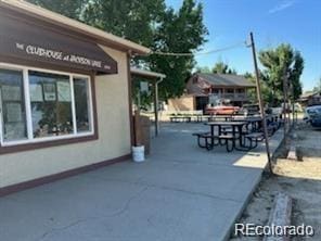 213 Kiowa Rd, Weldona, CO 80653 - view of home's exterior with stucco siding and a patio area