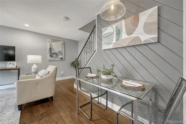1355 Gaylord St Unit 6, Denver, CO 80206 - dining area with wood finished floors, stairs, a textured ceiling, baseboards, and a baseboard heating unit