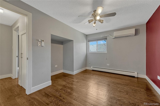1355 Gaylord St Unit 6, Denver, CO 80206 - empty room with baseboard heating, a wall mounted air conditioner, a ceiling fan, wood finished floors, and a textured ceiling