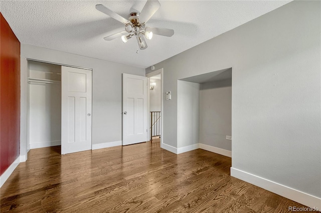 1355 Gaylord St Unit 6, Denver, CO 80206 - unfurnished bedroom featuring wood finished floors, a closet, baseboards, and a textured ceiling