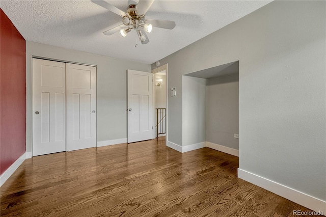1355 Gaylord St Unit 6, Denver, CO 80206 - unfurnished bedroom featuring wood finished floors, baseboards, a closet, ceiling fan, and a textured ceiling
