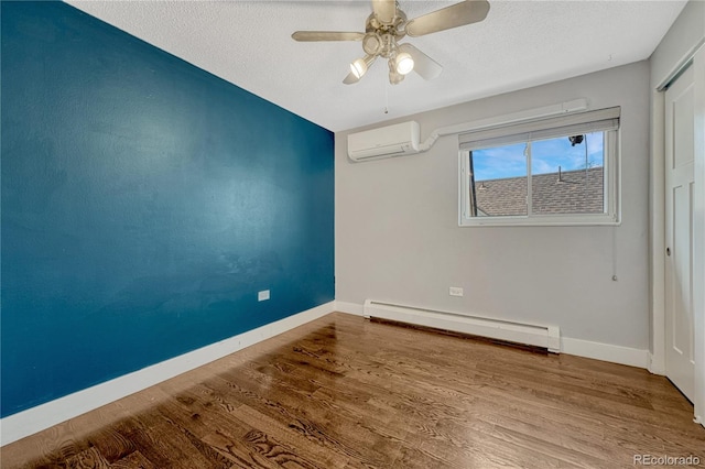 1355 Gaylord St Unit 6, Denver, CO 80206 - unfurnished bedroom with a baseboard heating unit, a wall mounted AC, baseboards, wood finished floors, and a closet