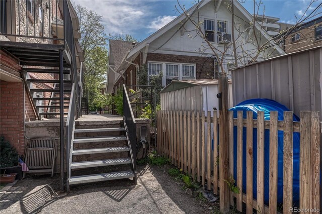 1355 Gaylord St Unit 6, Denver, CO 80206 - view of side of property with stairs, fence, and brick siding