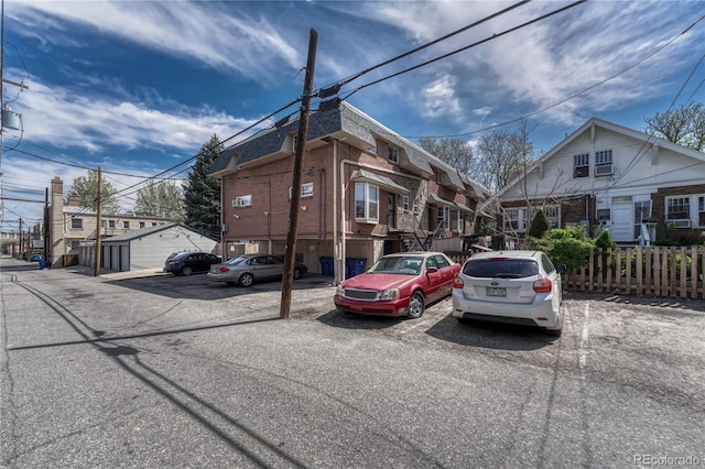 1355 Gaylord St Unit 6, Denver, CO 80206 - view of building exterior with uncovered parking, fence, and a residential view