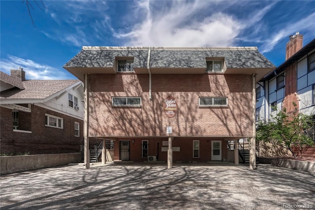 1355 Gaylord St Unit 6, Denver, CO 80206 - back of property with stairway, brick siding, and mansard roof