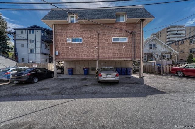 1355 Gaylord St Unit 6, Denver, CO 80206 - rear view of property with stairway, roof with shingles, and brick siding