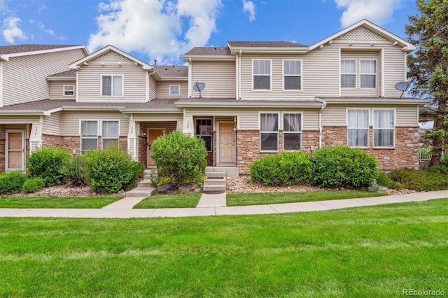 178 Blue Bonnet Dr, Brighton, CO 80601 - multi unit property with stone siding and a front yard