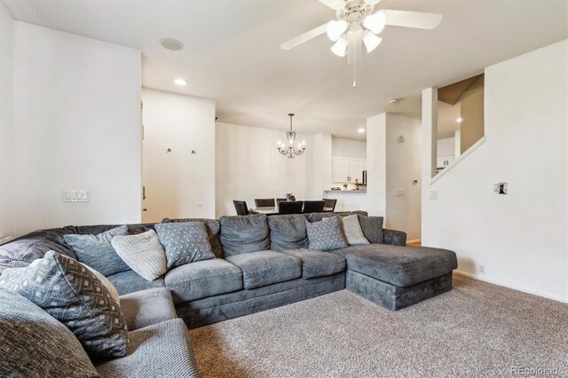 178 Blue Bonnet Dr, Brighton, CO 80601 - living room with a chandelier, ceiling fan, carpet flooring, recessed lighting, and stairs