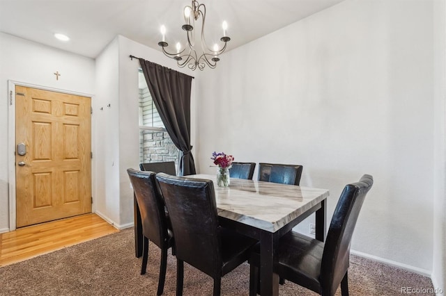 178 Blue Bonnet Dr, Brighton, CO 80601 - dining room featuring carpet flooring, a chandelier, and baseboards