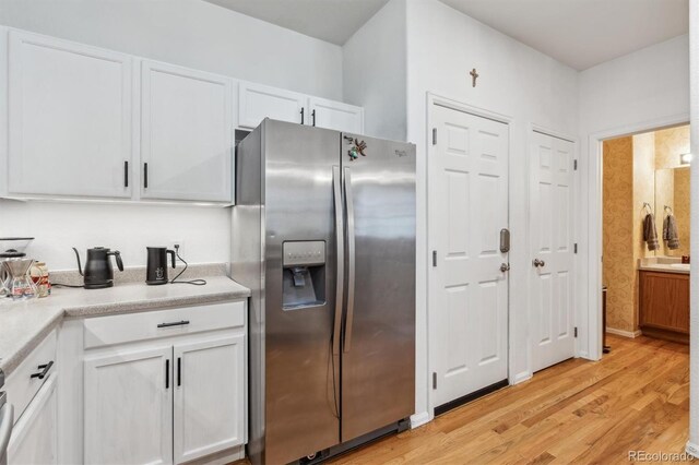 178 Blue Bonnet Dr, Brighton, CO 80601 - kitchen featuring stainless steel refrigerator with ice dispenser, white cabinetry, and light wood-type flooring
