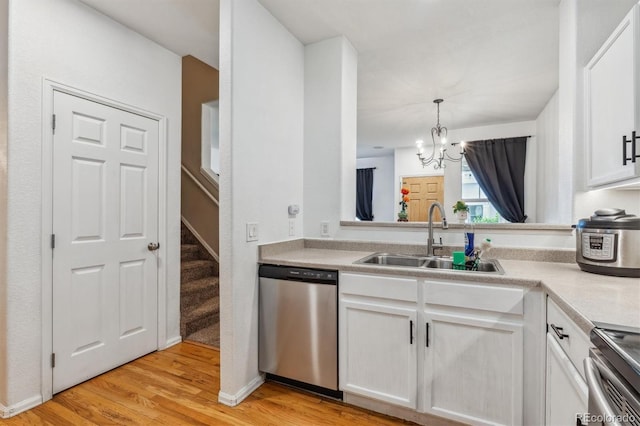 178 Blue Bonnet Dr, Brighton, CO 80601 - kitchen with stainless steel appliances, a sink, a chandelier, white cabinets, and light wood-style flooring