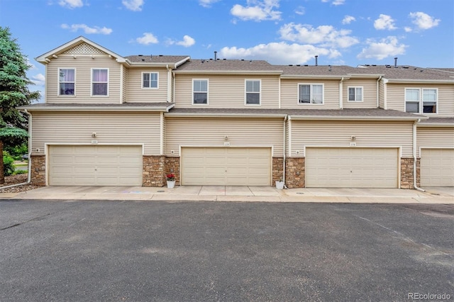 178 Blue Bonnet Dr, Brighton, CO 80601 - view of property with stone siding and a garage