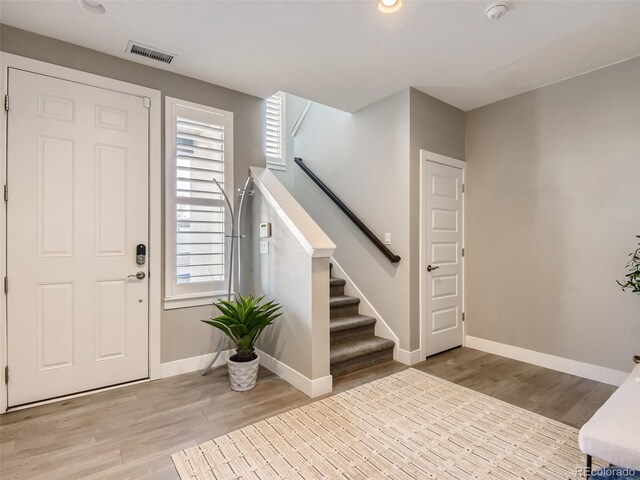 entryway featuring a wealth of natural light and hardwood / wood-style flooring