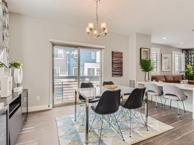 dining space featuring a chandelier and light hardwood / wood-style floors