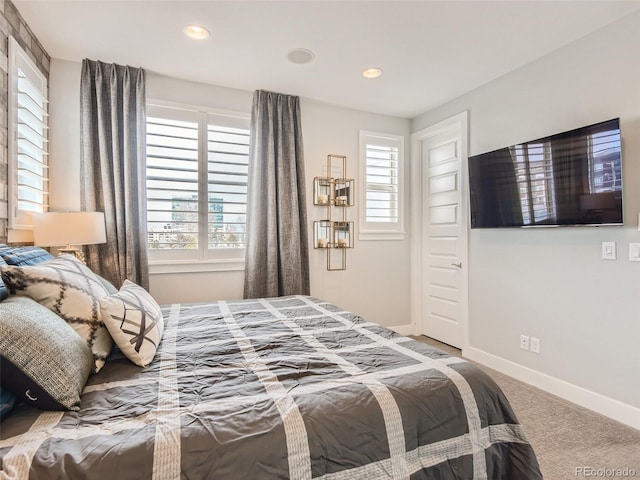 carpeted bedroom with multiple windows