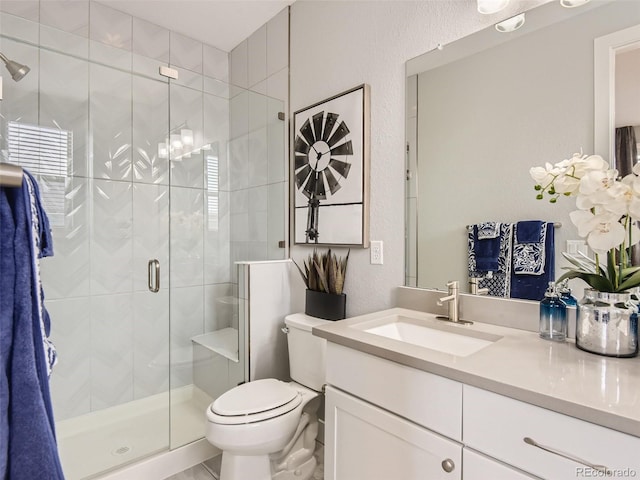 bathroom featuring vanity, toilet, and an enclosed shower