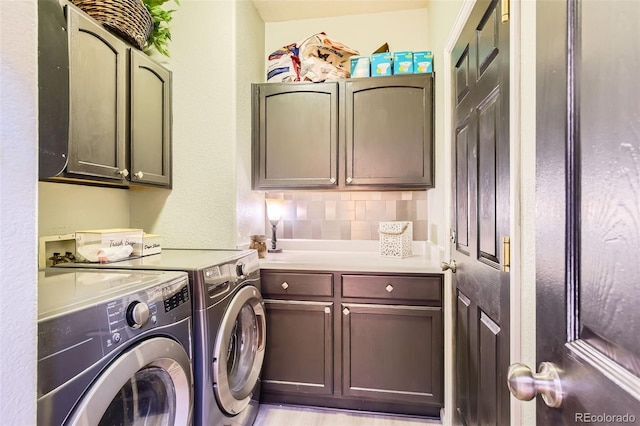 laundry room with cabinet space and separate washer and dryer