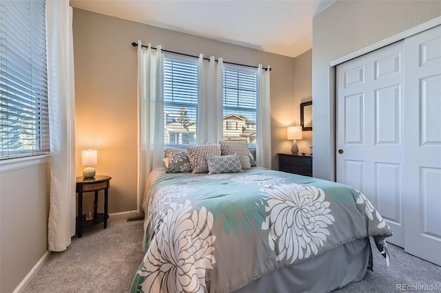 carpeted bedroom featuring a closet, visible vents, and baseboards