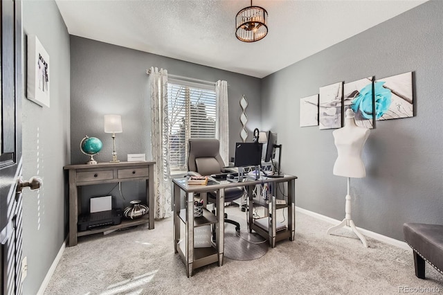 office space with carpet floors, a textured ceiling, and baseboards