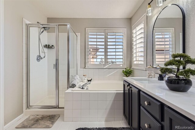 bathroom featuring a healthy amount of sunlight, a shower stall, vanity, and a bath